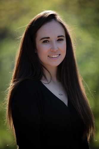 A smiling woman with long dark hair