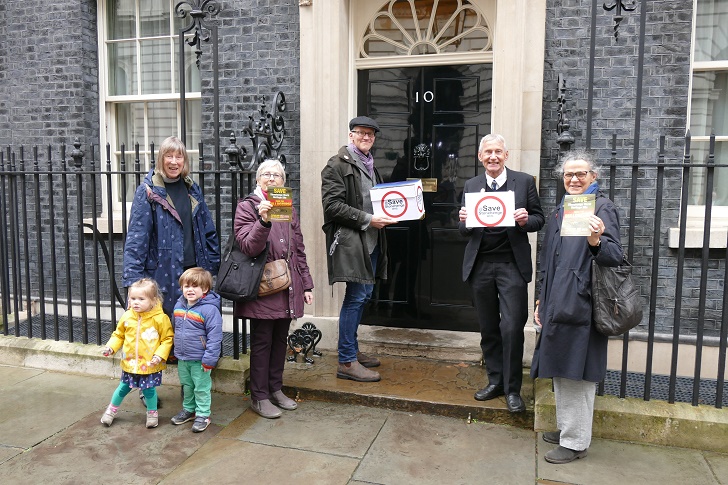 A group of people holding posters and petitions