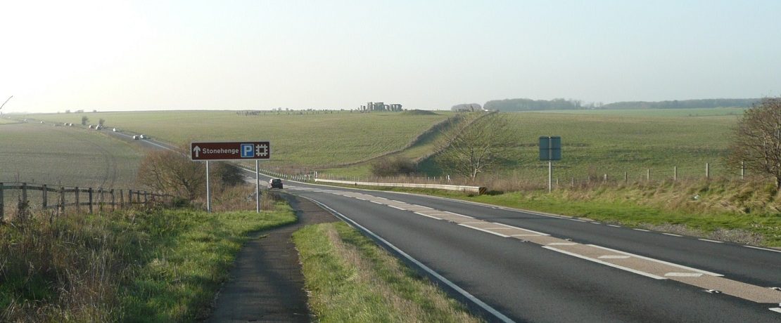 A large road approaching a stone monument