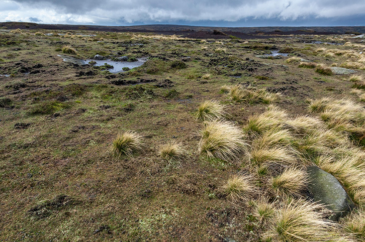Storm clouds passing over the windswept peat bog moorland plateau