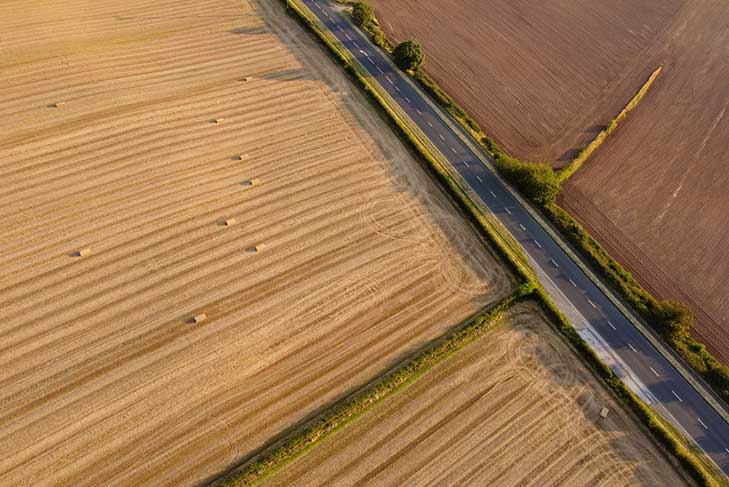 Aerial view of large fields with a hedgerow petering out