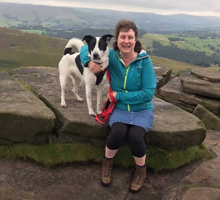Dog and walker on a moor in the Peak District
