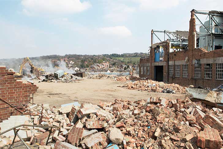 A factory site being cleared with a JCB