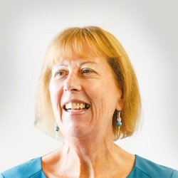 A smiling woman in blue top