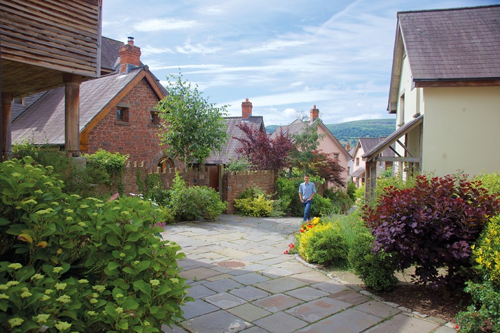 A person walking up a path in a hillside village