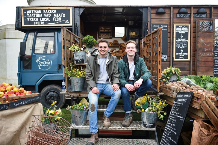 Two men serving at a mobile farm shop