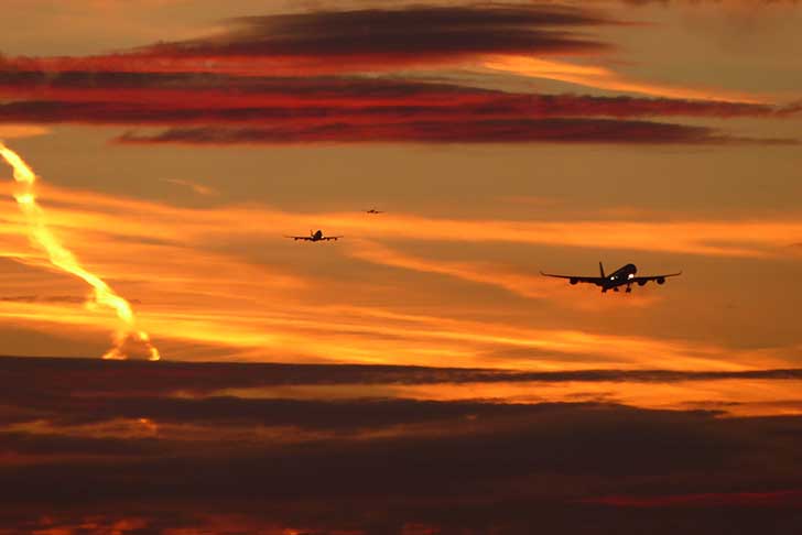 Three planes in a sunset sky