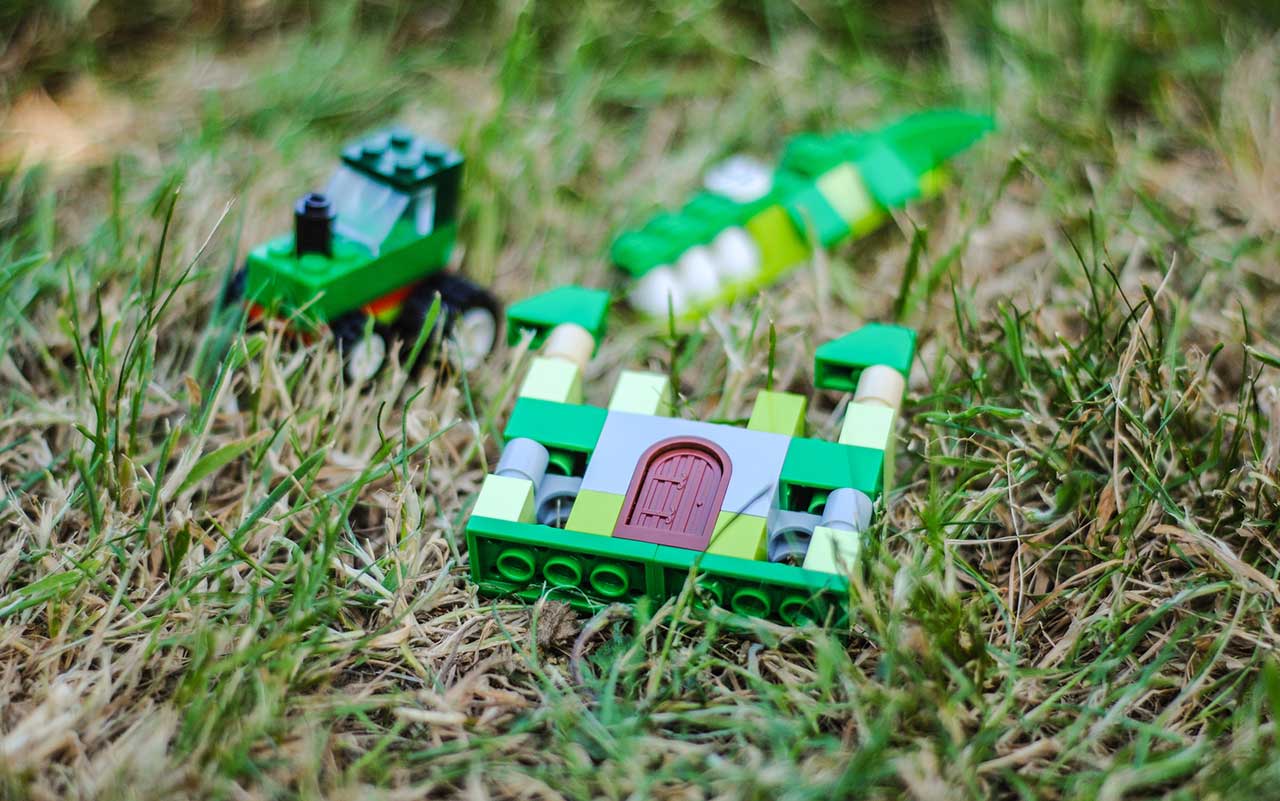 Green Lego building bricks in grass