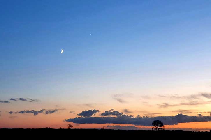 A warm wide sunset sky with shades of orange and blue