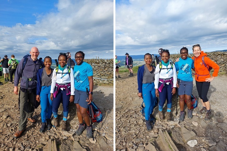 Two groups of people on top of a mountain smiling