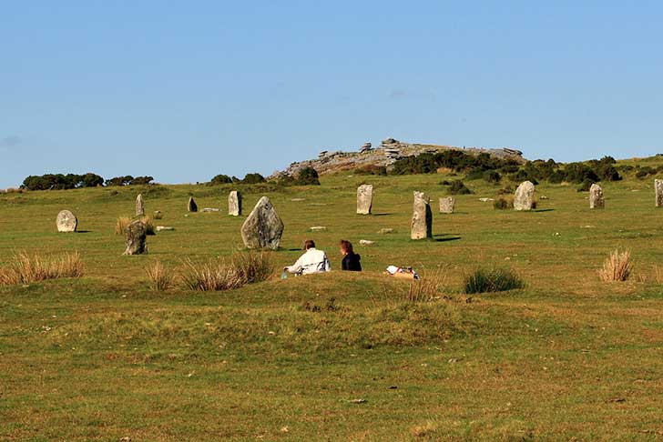 A scattering of standing stones on green grass
