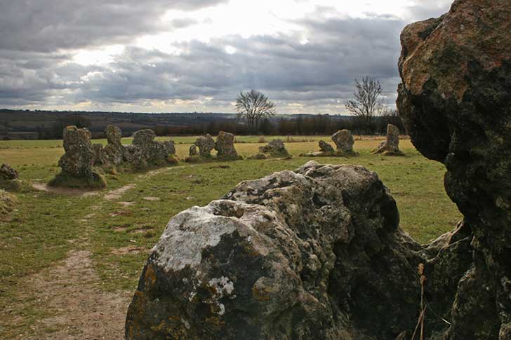 Textured, unusually-shaped stones under a cloudy sky