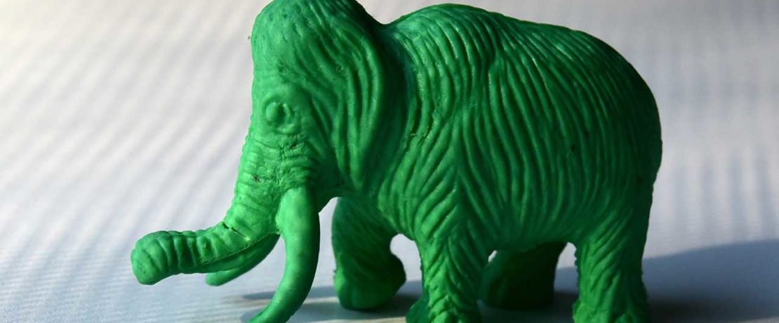 A green textured plastic toy elephant