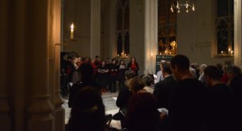 Soloist in front of choir at Christmas carol service