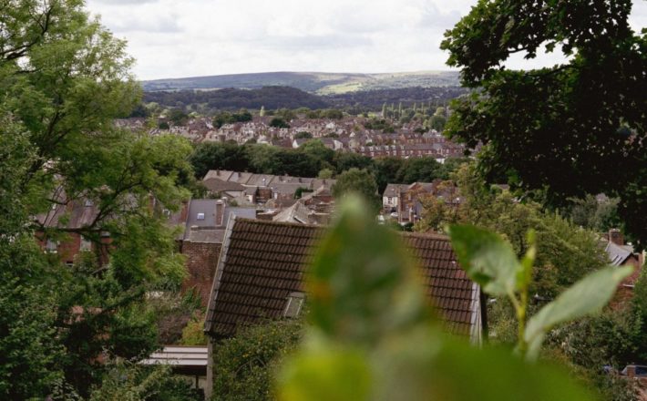 A view over rooftops with hills visible behind