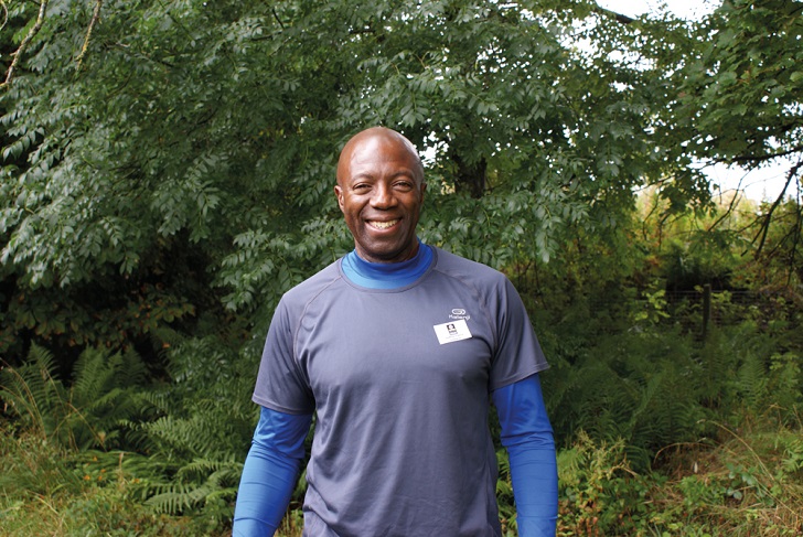 A black man in sportswear in the countryside