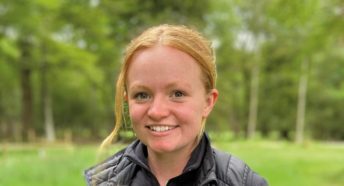 A smiling woman in the countryside