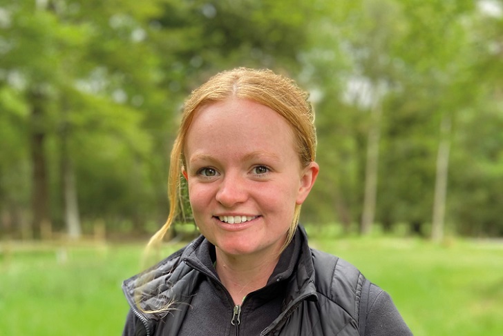 A smiling woman in the countryside