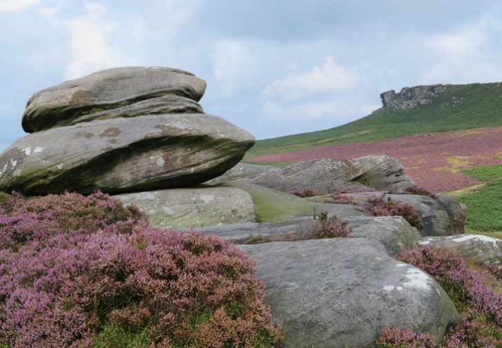 Light grey stone tor with heather around it