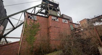 A dramatic red brick disused mine structure