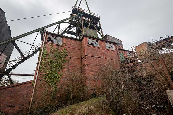 A dramatic red brick disused mine structure