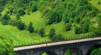 A viaduct in a lush green valley