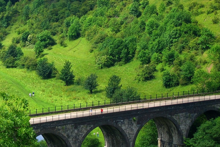 A viaduct in a lush green valley
