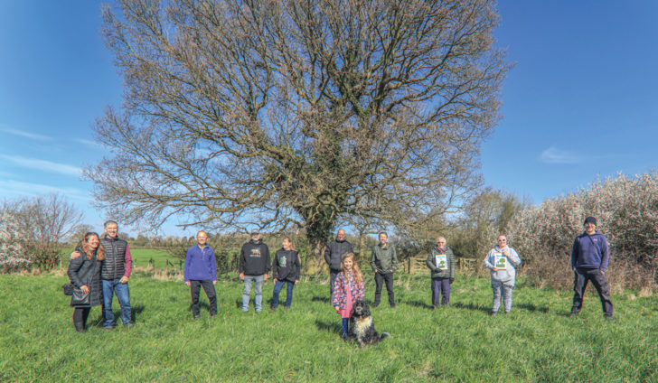 Campaigners stood in front of a tree a Longland Common