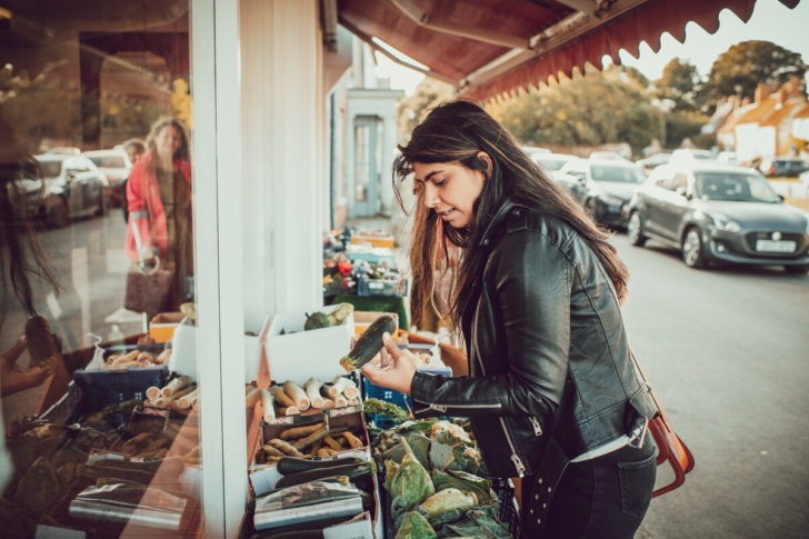 Woman looking at food outside village shop