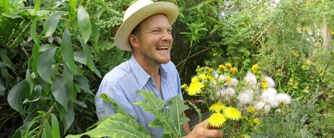 Tom Hart Dyke smiles while tending to his plants at Lullingstone Castle