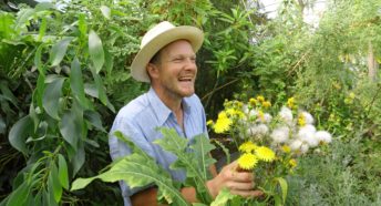 Tom Hart Dyke smiles while tending to his plants at Lullingstone Castle