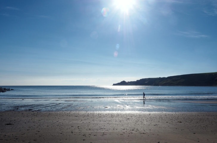 A view of Runswick Bay, North Yorkshire with a bright sun