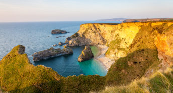 Cornwall's North Cliffs in sunlight, with blue sea