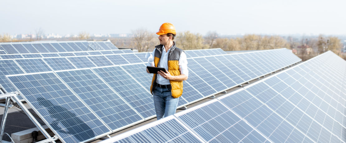 Man inspecting a rooftop solar installation