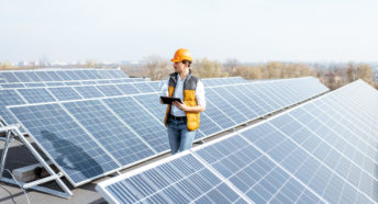 Man inspecting a rooftop solar installation