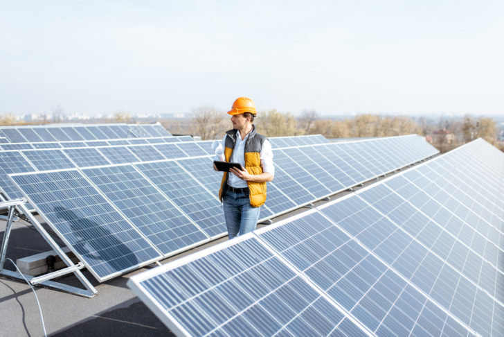 Man inspecting a rooftop solar installation