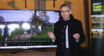 Man speaking in front of CPRE logo and screen showing hedgerow pictures.