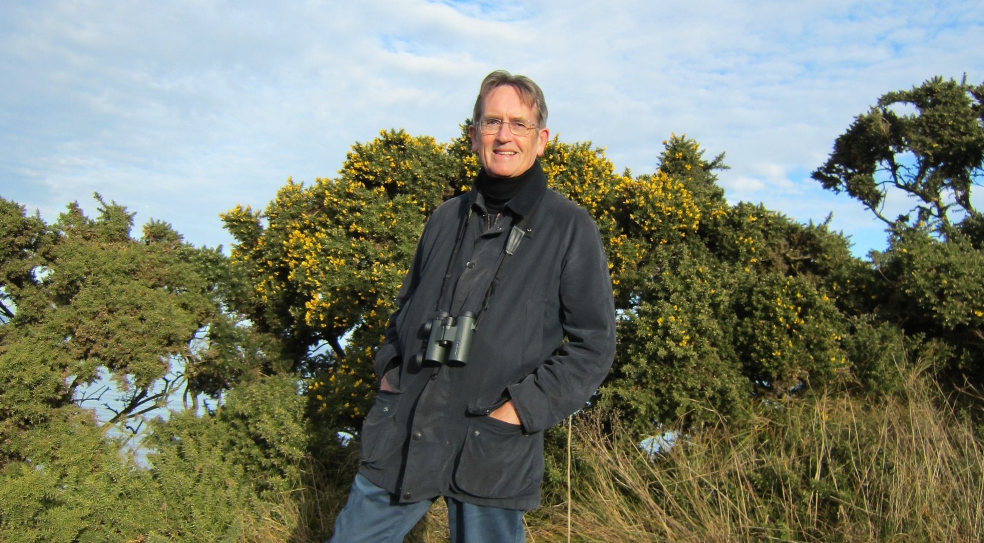 John D. James with gorse bushes in the background.