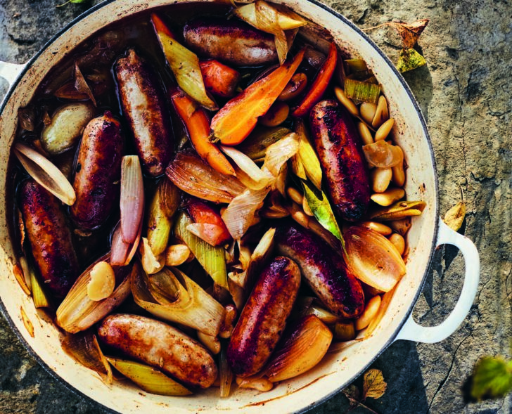 Sausage and cider stew in a casserole dish