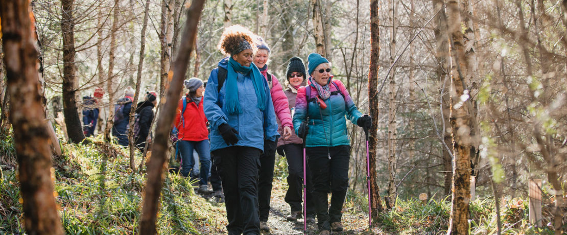 Group of women walking through a forest