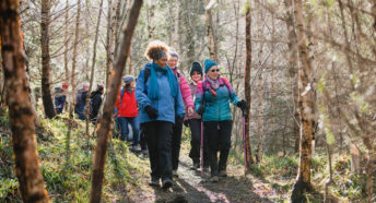 Group of women walking through a forest