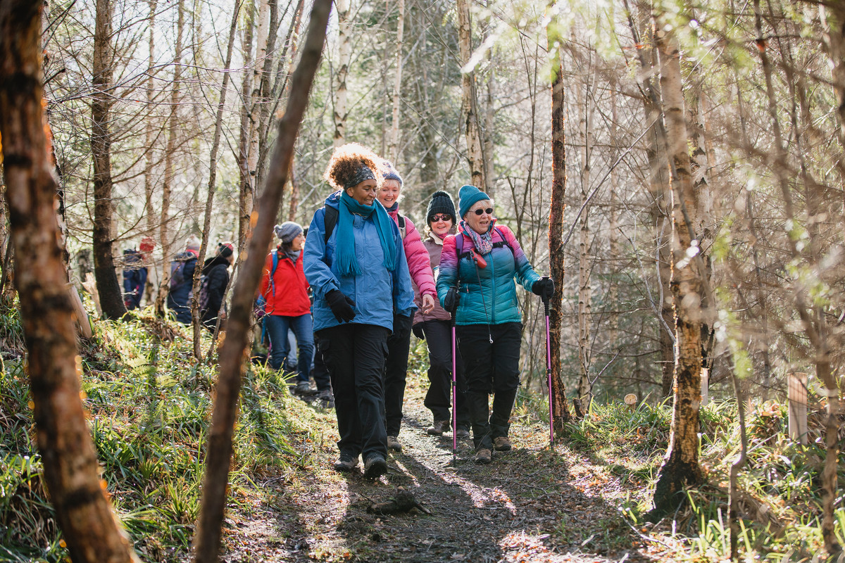 Group of women walking through a forest