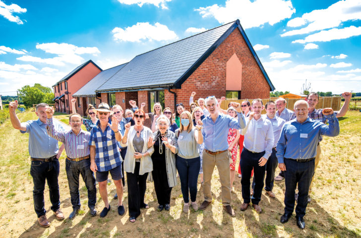 Residents and local politicians stand outside a new rural development in Groton, Suffolk