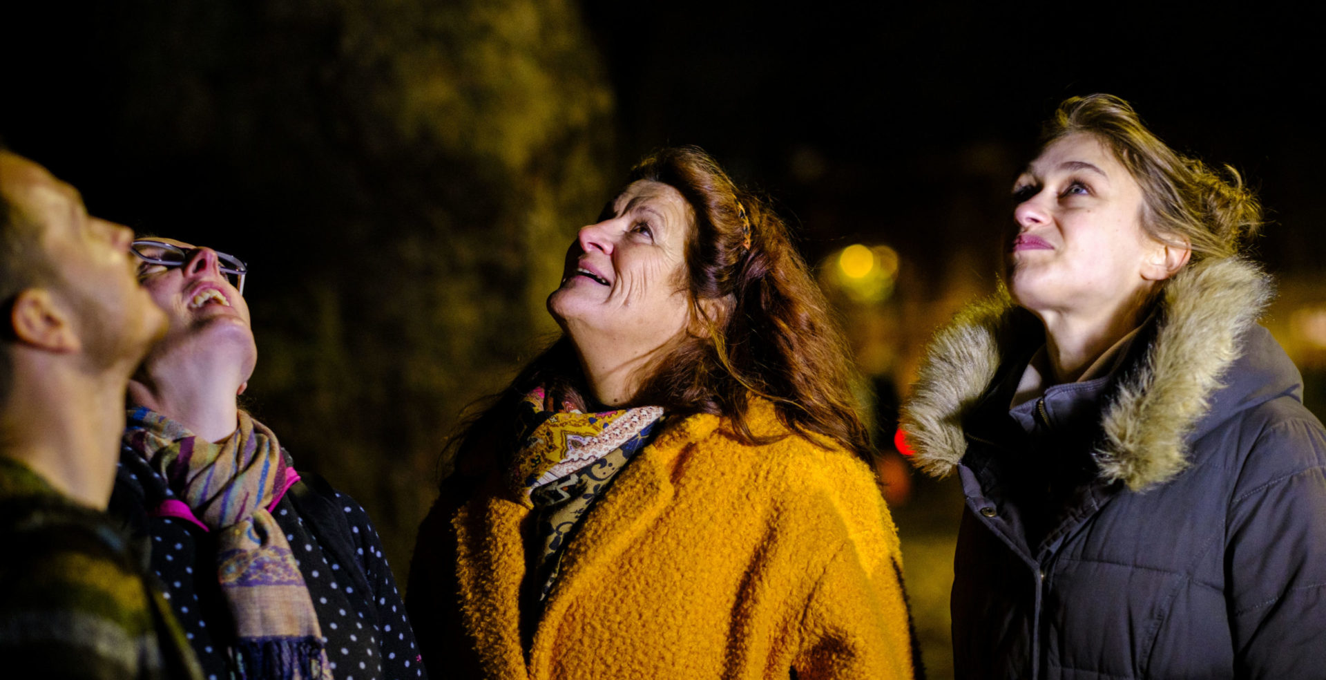 Group of friends taking part in Star Count, looking at the dark sky in amazement