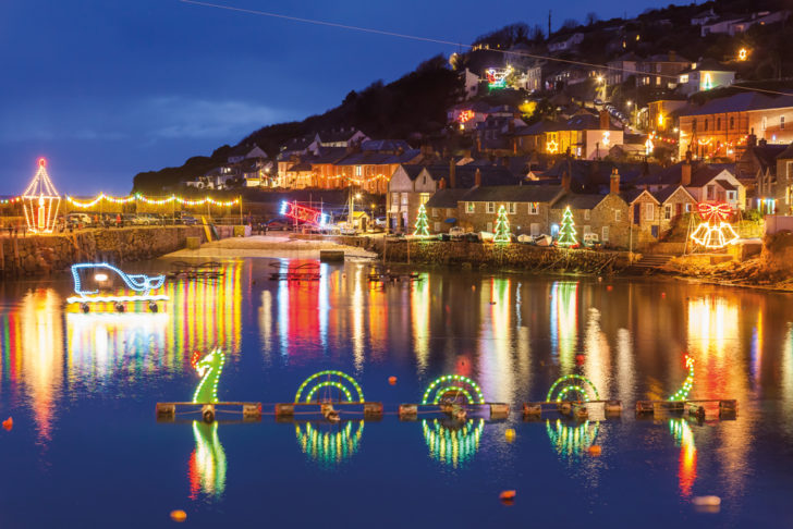 Vibrant lights reflecting off the water at Mousehole harbour