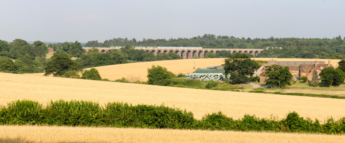 A view over Balcombe, West Sussex, including farmed fields and the Balcombe Viaduct
