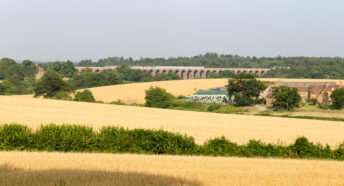 A view over Balcombe, West Sussex, including farmed fields and the Balcombe Viaduct