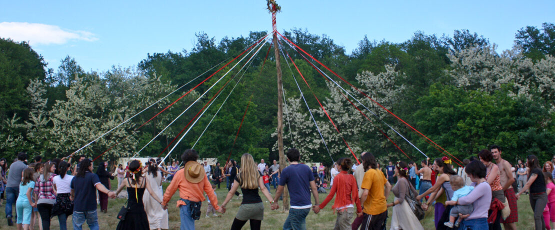 People dancing around a may pole