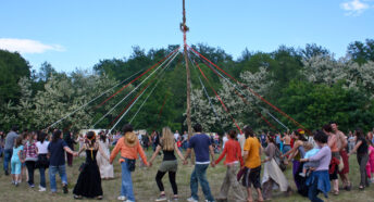 People dancing around a may pole