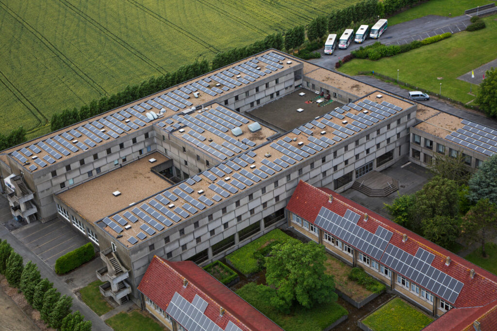 Photovoltaic solar panels on roof providing electricity by sun energy to office buildings